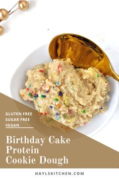 birthday cake protein cookie dough with sprinkles in a white bowl and gold spoon