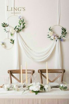 the table is set with flowers and candles