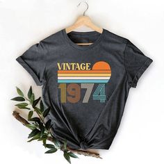 Vintage 1974 Shirt, Vintage Birthday Shirt, 50th Birthday shirt, 50th Birthday Gift, Retro 1974 Shirt, 50th Birthday Gift For Women and Man, Vintage 1974 Shirt,Vintage Bday tshirt,50th Birthday shirt,50th Birthday Gift,Retro 1974 Shirt,Bday Gift For women,Bday Gift For man,50th birthday women,50th birthday man,womens 1974 shirt,mans 1974 shirt,birthday age shirts,custom birthday gift Hi! Welcome to my store, I'm delighted to see you here. My store's main goal is to make you happy. I see you as a Vintage Letter Print Tops For Anniversary, Retro Birthday Shirt With Graphic Print, Vintage Crew Neck Shirt For Birthday, Vintage Short Sleeve Tops For Birthday, Retro Graphic Print T-shirt For Anniversary, Retro Graphic Print Tops For Anniversary, Retro Summer Tops For Anniversary, 50th Birthday Men, Birthday Man