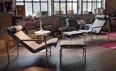 a living room filled with furniture and lots of windows