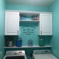 a washer and dryer in a small laundry room with blue paint on the walls