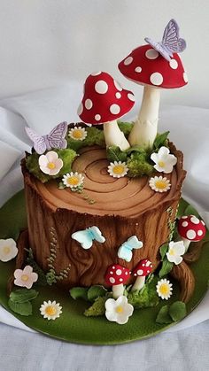 a cake decorated with mushrooms and flowers on a plate