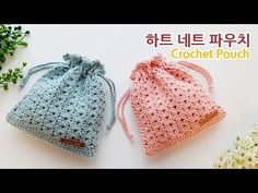 two crocheted bags sitting next to each other