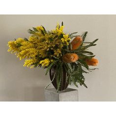 a vase filled with yellow flowers on top of a table