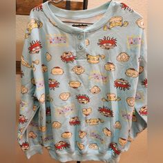 Size Large Rugrats Sleepwear Top For Women. Very Soft Material That Has Tommy, Chuckie, Phil And Lil, And Angelica. Blue Crew Neck Tops For Lounging, Cozy Blue Top For Lounging, Cozy Blue Tops For Lounging, Casual Long Sleeve Sleep Top, Casual Sleepwear With Cartoon Print And Crew Neck, Casual Cartoon Print Crew Neck Sleepwear, Cute Long Sleeve Sleep Tops, Blue Long Sleeve Sleepwear With Graphic Print, Blue Graphic Print Long Sleeve Sleepwear