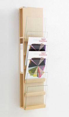 a book shelf with three different colored umbrellas hanging on it's sides,