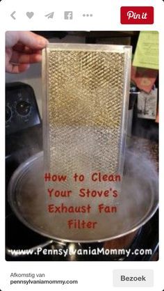 a person is cleaning the stove with an exhaust fan filter