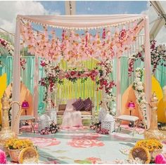 a decorated stage with flowers and chairs