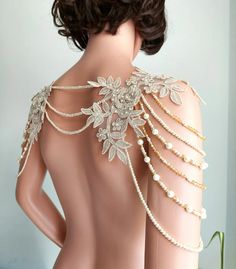 the back of a mannequin's torso with pearls and leaves on it