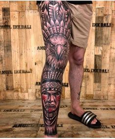 a man's leg with tattoos on it and an eagle in the middle of his leg