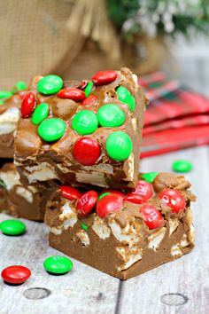 three pieces of candy bar sitting on top of each other with m & m candies all over them