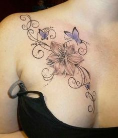 a woman's chest with flowers and butterflies on it