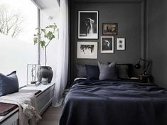 a bedroom with black walls and pictures on the wall