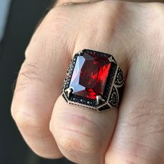 Introducing our exquisite Ruby Silver Men's Ring, featuring a captivating red Garnet stone. Handcrafted with love, this unique piece showcases a stunning Ottoman style design that effortlessly combines tradition and modernity. Made with high-quality 925k sterling silver, this ring exudes a luxurious feel and guarantees exceptional durability. This remarkable masterwork is the perfect gift for that special man in your life, making it an ideal choice for birthdays, anniversaries, or any special oc Luxury Red Gemstones With Accent Stones, Red Engraved Signet Ring For Formal Occasion, Formal Red Engraved Signet Ring, Ruby Gemstones As Fine Jewelry Gift, Ruby Gemstones For Gifts In Fine Jewelry Style, Fine Ruby Gemstones For Gifts, Fine Ruby Gemstones As A Gift, Classic Red Ruby Signet Ring, Fine Jewelry Red Ruby Gemstones