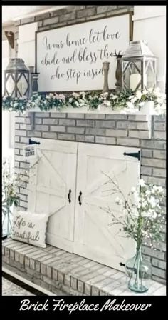 a brick fireplace with two white doors and flowers in vases on the mantel