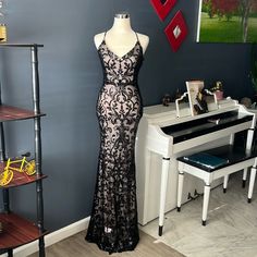 Beautiful Long Party Dress Lined With Sequin V-Neck And Cross Back And Back Zipper In The Back With Label New Black Lace V-neck Evening Dress, Lace V-neck Evening Dress For Party, Black Backless Evening Dress For Spring, Black Lace Backless Maxi Dress, Lace V-neck Maxi Dress For Party, Party Lace V-neck Maxi Dress, Black V-neck Evening Dress For Night Out, Black V-neck Evening Dress For Party Season, Black V-neck Evening Dress For Spring