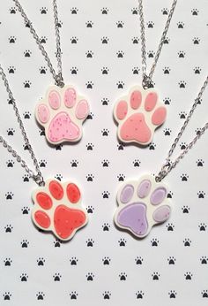 "this cute pawprint necklace makes a great gift for any animal and/or glitter lover!  made using a flat resin glitter pendant hung from silver plated chain.  total length of chain measures approx. 16\" and fastens with a lobster clasp fastener.  pendant measures approx. 37mm x 34mm  * available in bright pink, lilac, pale pink and pink * * matching keyrings also available in our shop! *" Round Pendant Necklace With Paw Print For Gift, Paw Print Pendant Necklace Gift, Paw Print Pendant Necklace For Gifts, Paw Print Pendant Necklace For Gift, Pendant Necklace With Paw Print For Gift, Resin Glitter, Pink Lilac, Gifts For Pet Lovers, Necklace Pendant