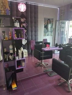 a hair salon with purple tile floors and chairs in front of the mirror on the wall