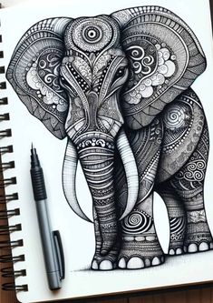 an elephant with intricate designs on it's face is shown next to a pen