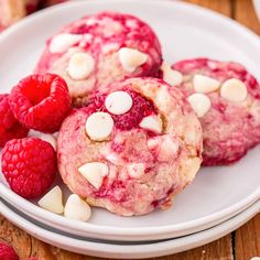 raspberry white chocolate chip cookies on a plate with fresh raspberries and marshmallows