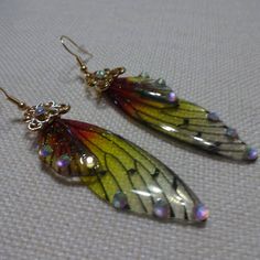 pair of earrings with multicolored butterfly wings