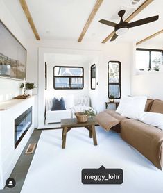 a living room filled with furniture and a ceiling fan