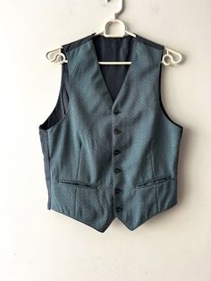 Vintage Mens Vest Steampunk Formal Vest Hazy Blue Waistcoat Gentleman's Edwardian Victorian Vest Extra small to small Size Office Mens Vest Groom vest Estimated size: XS/S Measurements (lying flat): Length: 20.5"/ 52 cm Pit to pit: 18.5"/ 47 cm Waist: 17.5"/ 44.5 cm Please check measurements to insure a proper fit. Remember to allow yourself some extra room for movement. You can compare these with something from your closet that fits you well. This vest will come to you freshly laundered and rea Blue Sleeveless Outerwear With Buttons, Fitted Blue Vest With Buttons, Blue Fitted Vest For Fall, Fitted Blue Vest Outerwear, Tailored Sleeveless Blue Vest, Tailored Blue Vest For Fall, Steampunk Formal, Vest Groom, Victorian Vest