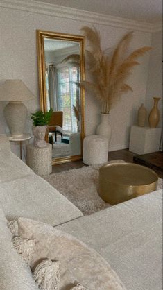 a living room filled with furniture and a large mirror