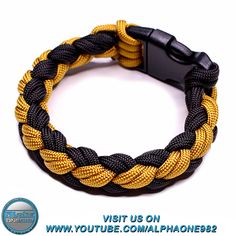 a yellow and black rope bracelet with a black clasp on it's end, which is