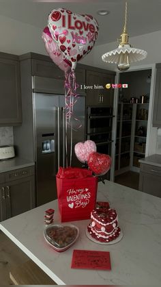 valentine's day cake and balloons on the kitchen counter