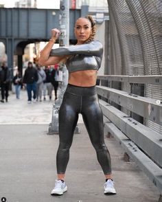 a woman is posing for the camera with her arms crossed