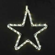 a star shaped light up decoration on a black background