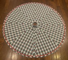 an open umbrella sitting on top of a wooden floor