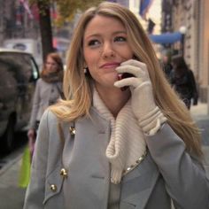 a woman talking on her cell phone while walking down the street