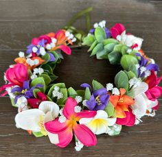 a colorful flower wreath sitting on top of a wooden table