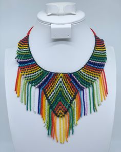 This beautiful beaded necklace is hand-woven by the women of the Embera Chami Indigenous Tribe of Colombia Handwoven Beaded Bracelets With Round Beads, Traditional Fair Trade Beaded Necklaces With Round Beads, Handwoven Necklace For Beach, Traditional Handwoven Necklaces For Festivals, Traditional Handwoven Necklace For Festivals, Artisan Multicolor Hand-strung Necklaces, Multicolor Handwoven Festival Necklaces, Multicolor Handwoven Necklaces For Festivals, Fair Trade Multicolor Round Bead Jewelry