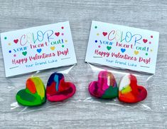 two heart shaped lollipops in cellophane bags