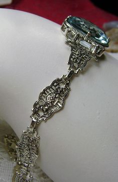 "<> (Made To Order) This is a brand new Victorian/Art Deco Reproduction filigree sterling silver gemstone bracelet. The gorgeous 6ct oval cut Simulated/man-made aquamarine gemstone is 14mm x 10mm x 6mm in dimension. Notice the beautiful craftsmanship of the filigree settings and links. This is a well made beautiful bracelet and it is ready to wear. The bracelet is adjustable and will fit from 7\" to 8.5.\"The color and clarity of each gemstone are excellent. A gift-box is included for safe Classic Formal Bracelets With Decorative Band, Classic Bracelets With Decorative Band For Formal Occasions, Victorian Jewelry With Decorative Band For Formal Occasions, Victorian Formal Jewelry With Decorative Band, Art Deco Oval Filigree Jewelry, Oval Art Deco Filigree Jewelry, Victorian Silver Jewelry With Decorative Band, Antique Oval Silver Bracelets, Antique Silver Oval Bracelets