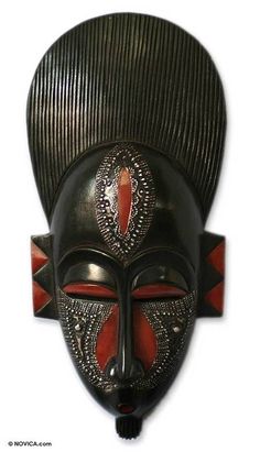 a black mask with red accents on it's face is shown against a white background