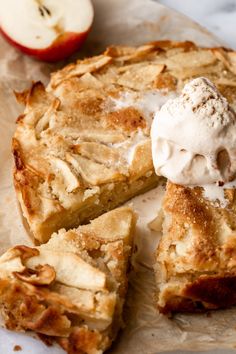 an apple pie with ice cream on top and two pieces cut out to show the filling