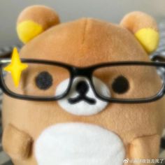 a teddy bear wearing glasses with a star on its nose