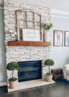 a living room filled with furniture and a fire place in front of a brick fireplace