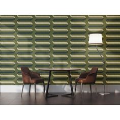 two chairs and a table in front of a wall with an abstract pattern on it