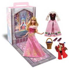 the doll is wearing a pink dress and has a basket in front of it,