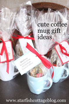 some coffee mugs wrapped in plastic and tied with red ribbon