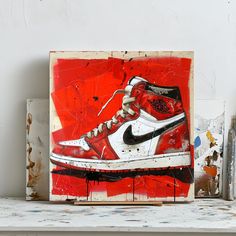 a painting of a red and white shoe on a shelf