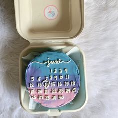 a cake in a box with the date and time on it for someone to celebrate