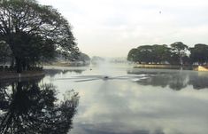 the water is reflecting the sky and trees