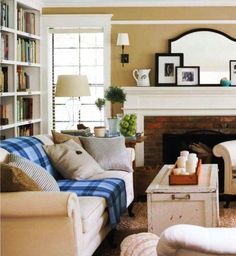 a living room filled with furniture and a fire place on top of a white table