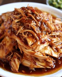 a white plate topped with shredded meat and sauce